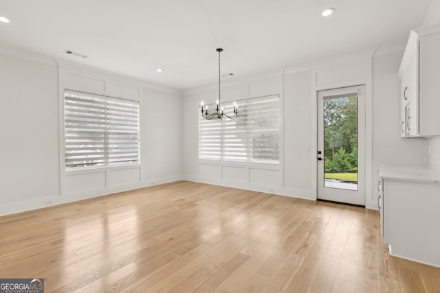 3735 Hamilton Mill Rd, Buford, GA 30519 - unfurnished dining area with a chandelier, recessed lighting, light wood finished floors, and crown molding