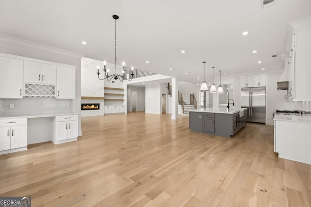 3735 Hamilton Mill Rd, Buford, GA 30519 - kitchen featuring built in fridge, open floor plan, ornamental molding, backsplash, and white cabinets