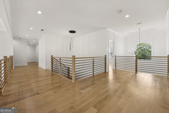 3735 Hamilton Mill Rd, Buford, GA 30519 - corridor featuring a chandelier, light wood finished floors, an upstairs landing, recessed lighting, and a decorative wall