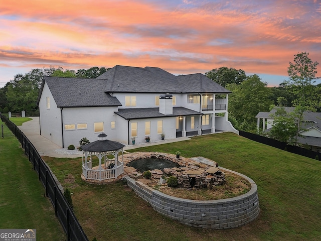 3735 Hamilton Mill Rd, Buford, GA 30519 - back of property with a gazebo, a balcony, a fenced backyard, a shingled roof, and a patio