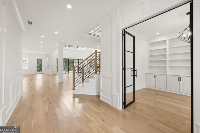 3735 Hamilton Mill Rd, Buford, GA 30519 - hallway with stairway, built in shelves, light wood finished floors, recessed lighting, and a chandelier