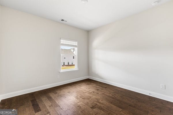 1494 Weeping Tree Cir, Hoschton, GA 30548 - empty room featuring wood finished floors and a smoke detector
