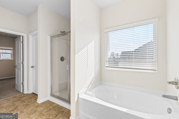 1494 Weeping Tree Cir, Hoschton, GA 30548 - bathroom featuring a bath and a stall shower