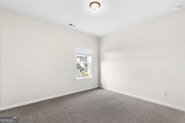 1494 Weeping Tree Cir, Hoschton, GA 30548 - spare room with carpet flooring and baseboards