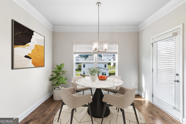 1494 Weeping Tree Cir, Hoschton, GA 30548 - dining space with a chandelier, ornamental molding, healthy amount of natural light, and wood finished floors