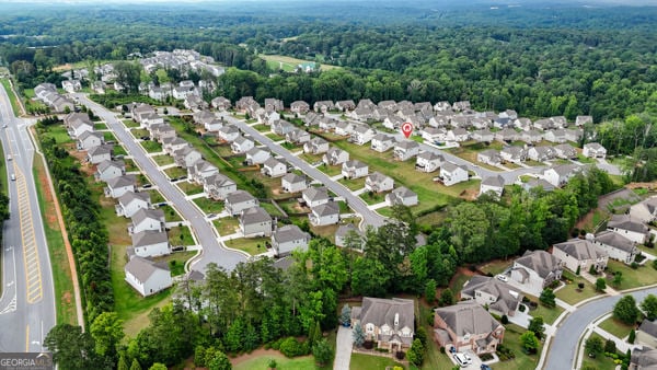 1494 Weeping Tree Cir, Hoschton, GA 30548 - aerial view of property and surrounding area featuring nearby suburban area and a forest