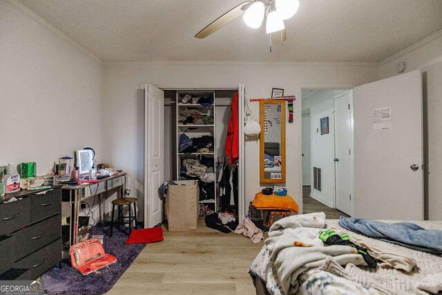 2505 Broad St W Unit 314, Athens, GA 30606 - bedroom featuring ornamental molding, wood finished floors, a closet, ceiling fan, and a textured ceiling