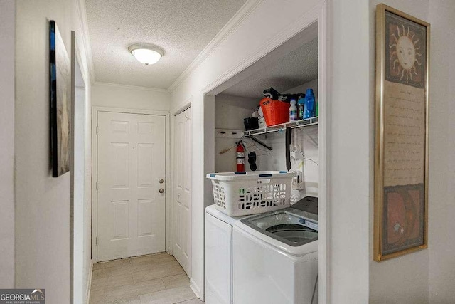 2505 Broad St W Unit 314, Athens, GA 30606 - laundry room featuring washer and clothes dryer, a textured ceiling, ornamental molding, and light tile patterned flooring