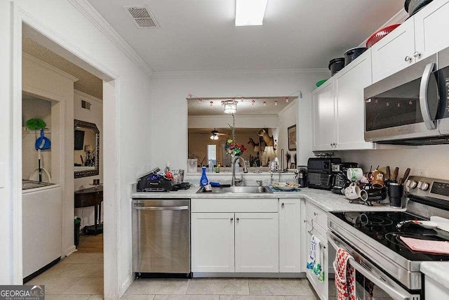 2505 Broad St W Unit 314, Athens, GA 30606 - kitchen with stainless steel appliances, crown molding, light countertops, white cabinets, and light tile patterned flooring