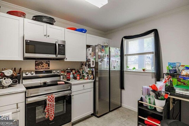 2505 Broad St W Unit 314, Athens, GA 30606 - kitchen featuring appliances with stainless steel finishes, light countertops, ornamental molding, white cabinets, and light tile patterned floors