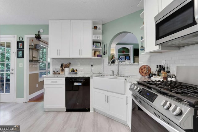 3820 Pheasant Run Trce, Cumming, GA 30028 - kitchen with stainless steel appliances, open shelves, white cabinetry, backsplash, and a textured ceiling