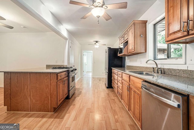 1260 Fork Creek Trl, Decatur, GA 30033 - kitchen featuring stainless steel appliances, ceiling fan, light wood finished floors, and brown cabinetry
