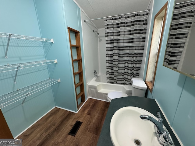 919 Louis Rd, Rentz, GA 31075 - bathroom with shower / bath combo with shower curtain, wood finished floors, and a textured ceiling