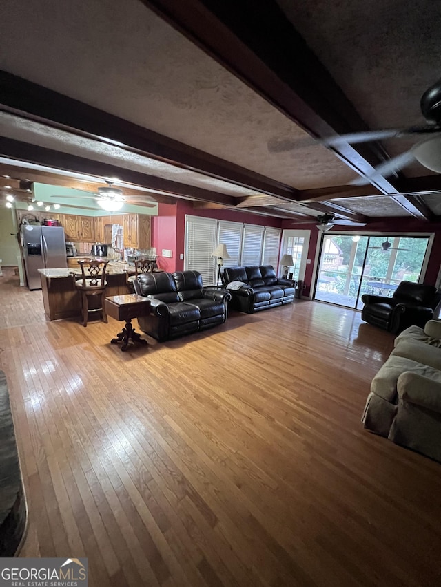 186 Kingston Rd, Colbert, GA 30628 - living room featuring ceiling fan, light wood-type flooring, and beam ceiling