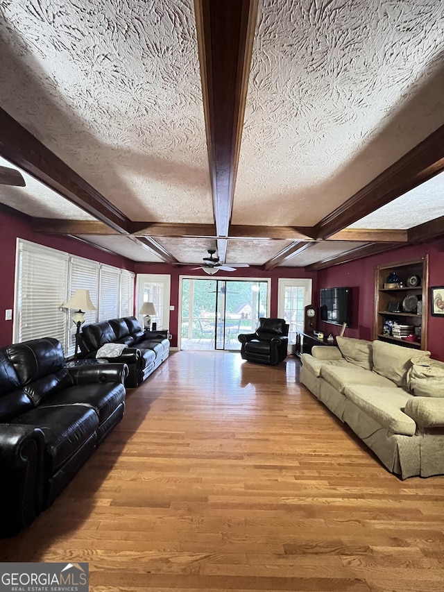 186 Kingston Rd, Colbert, GA 30628 - living area featuring a textured ceiling, wood finished floors, a ceiling fan, and beam ceiling