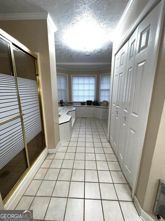 186 Kingston Rd, Colbert, GA 30628 - bathroom with a textured ceiling, a garden tub, tile patterned flooring, a shower stall, and ornamental molding