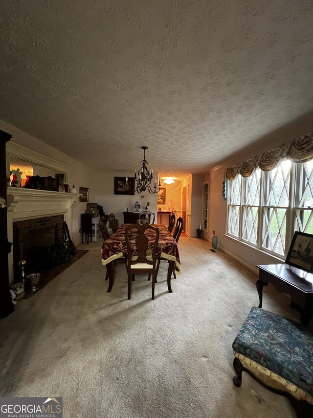 186 Kingston Rd, Colbert, GA 30628 - dining area with a textured ceiling, a chandelier, a brick fireplace, and carpet floors