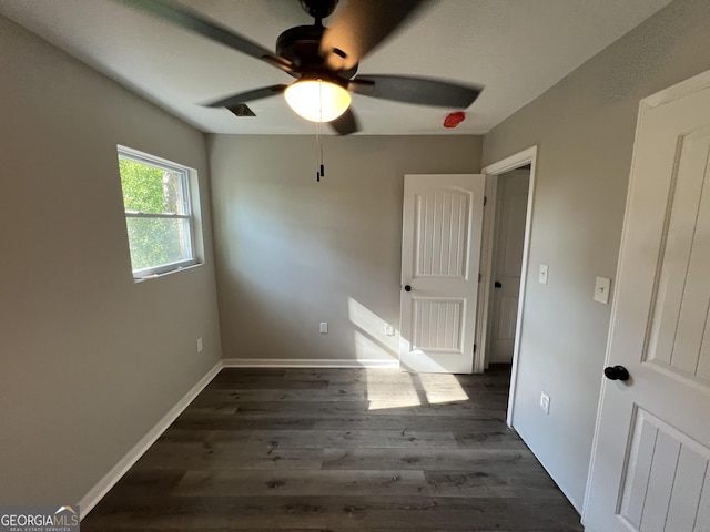 7128 Lady Heidi Ct, Jonesboro, GA 30236 - unfurnished bedroom featuring dark wood-type flooring and a ceiling fan