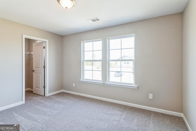 105 Ivy Glen Dr, Perry, GA 31069 - unfurnished bedroom with light colored carpet, a spacious closet, and a closet