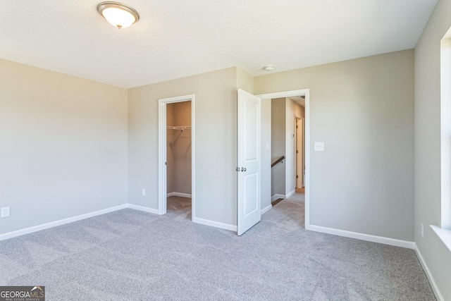 105 Ivy Glen Dr, Perry, GA 31069 - unfurnished bedroom featuring carpet flooring, a spacious closet, and a closet