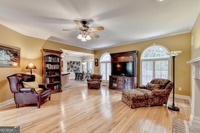 1640 Mount Mckinley Dr, Grayson, GA 30017 - living room with a ceiling fan, light wood-type flooring, a fireplace with flush hearth, and ornamental molding