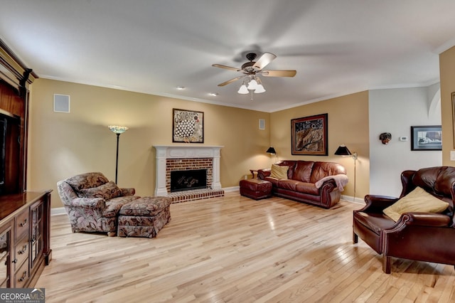 1640 Mount Mckinley Dr, Grayson, GA 30017 - living area with light wood-type flooring, a ceiling fan, a fireplace, and ornamental molding
