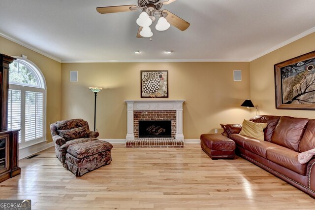 1640 Mount Mckinley Dr, Grayson, GA 30017 - living room featuring light wood-style floors, crown molding, a fireplace, and ceiling fan