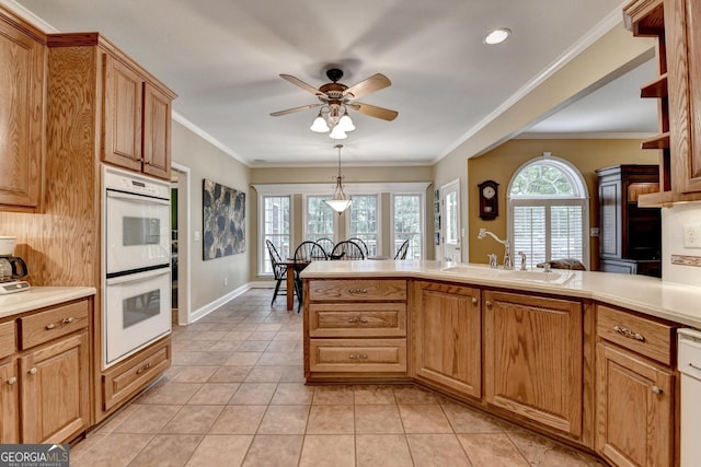 1640 Mount Mckinley Dr, Grayson, GA 30017 - kitchen with double oven, a ceiling fan, light tile patterned floors, light countertops, and crown molding