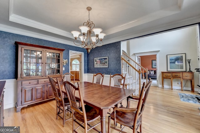 1640 Mount Mckinley Dr, Grayson, GA 30017 - dining room with a tray ceiling, a chandelier, light wood-style floors, stairs, and wallpapered walls