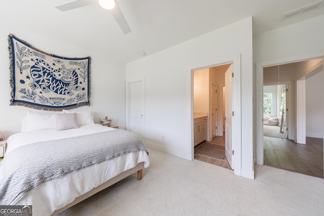 15755 Burdette Ct, Milton, GA 30004 - bedroom with light colored carpet, ceiling fan, and connected bathroom