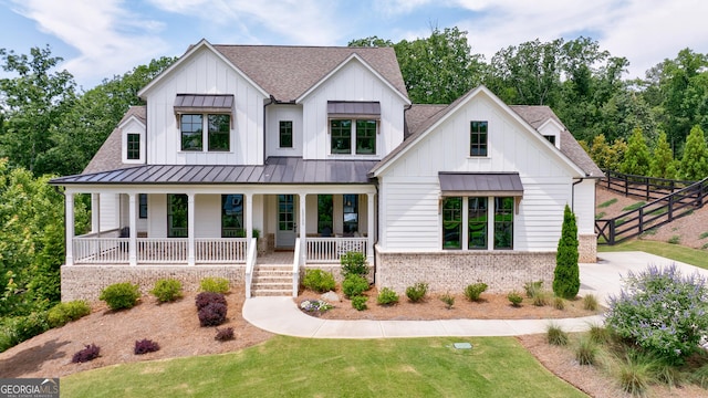 15755 Burdette Ct, Milton, GA 30004 - modern farmhouse style home featuring roof with shingles, a standing seam roof, and board and batten siding