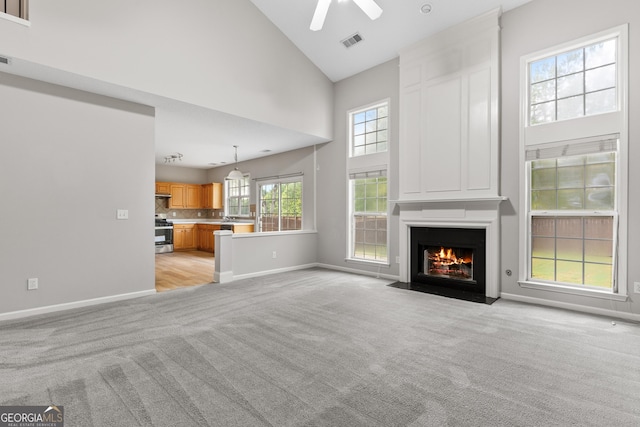 8750 Redford Ln, Suwanee, GA 30024 - unfurnished living room with light carpet, high vaulted ceiling, a ceiling fan, and a large fireplace