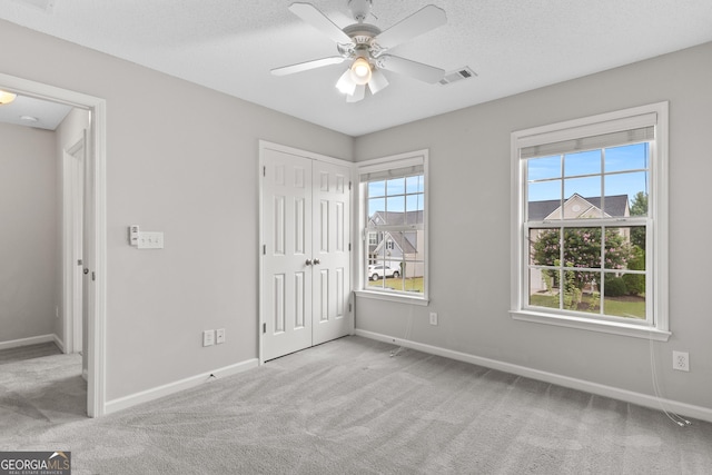 8750 Redford Ln, Suwanee, GA 30024 - unfurnished bedroom with carpet flooring, a closet, and a ceiling fan