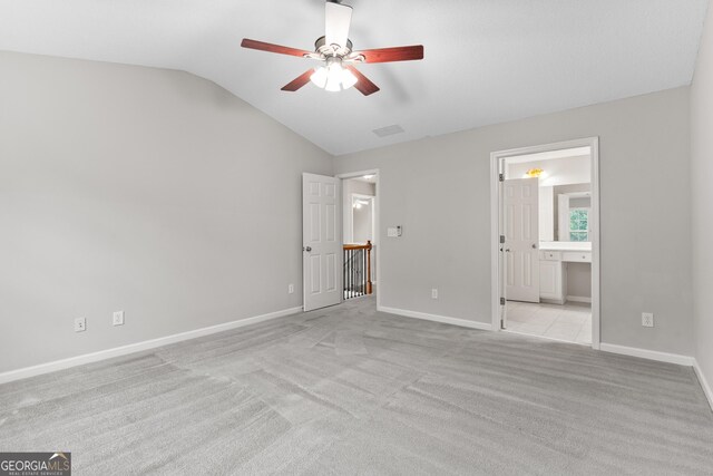 8750 Redford Ln, Suwanee, GA 30024 - unfurnished bedroom with vaulted ceiling, carpet floors, connected bathroom, and ceiling fan