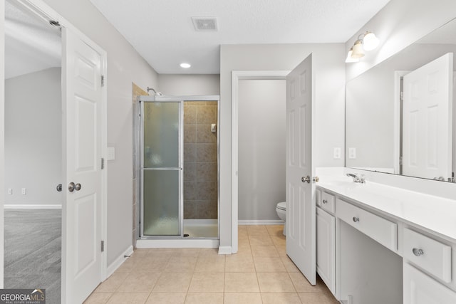 8750 Redford Ln, Suwanee, GA 30024 - bathroom with a shower stall, vanity, tile patterned floors, and a textured ceiling