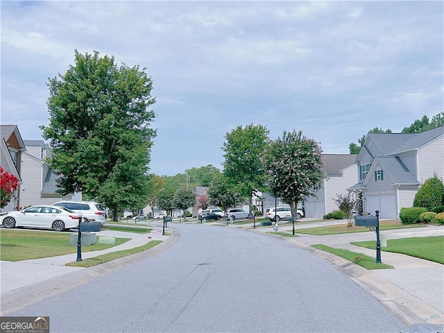 8750 Redford Ln, Suwanee, GA 30024 - view of asphalt road with a residential view, sidewalks, and curbs