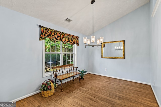 5832 Sycamore Ridge Dr, Sugar Hill, GA 30518 - living area featuring wood finished floors, lofted ceiling, a chandelier, and a textured ceiling