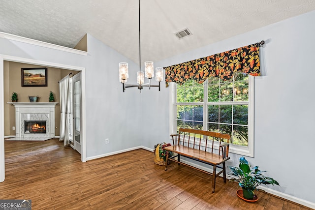 5832 Sycamore Ridge Dr, Sugar Hill, GA 30518 - dining space featuring a chandelier, a premium fireplace, wood finished floors, and a textured ceiling