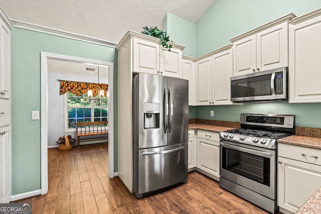 5832 Sycamore Ridge Dr, Sugar Hill, GA 30518 - kitchen with stainless steel appliances, dark wood-style flooring, a textured ceiling, and dark stone countertops