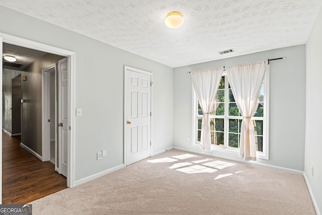 5832 Sycamore Ridge Dr, Sugar Hill, GA 30518 - unfurnished bedroom featuring carpet and a textured ceiling