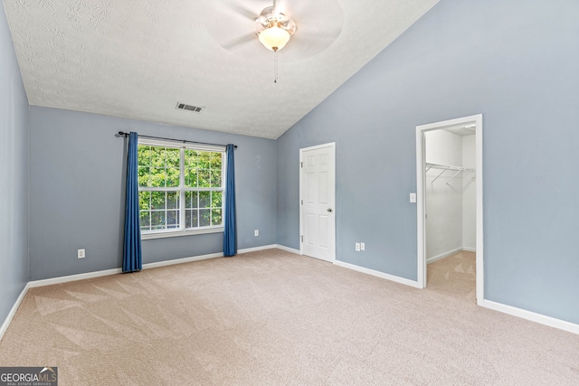 5832 Sycamore Ridge Dr, Sugar Hill, GA 30518 - unfurnished bedroom featuring carpet floors, a spacious closet, ceiling fan, a textured ceiling, and high vaulted ceiling