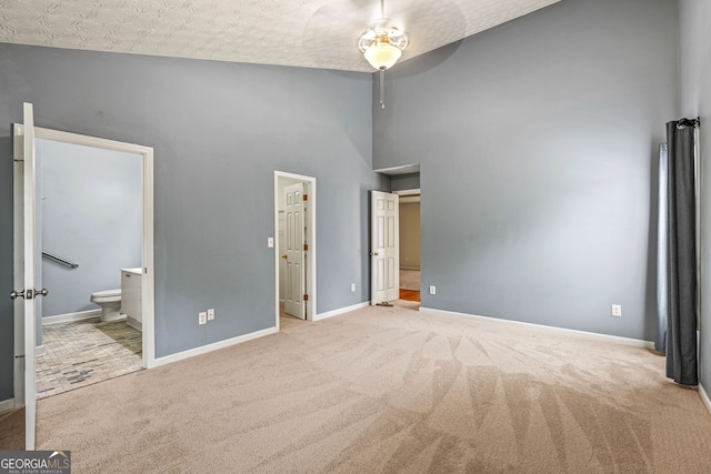 5832 Sycamore Ridge Dr, Sugar Hill, GA 30518 - unfurnished bedroom with carpet floors, ensuite bath, and a high ceiling