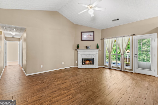 5832 Sycamore Ridge Dr, Sugar Hill, GA 30518 - unfurnished living room with lofted ceiling, wood finished floors, a high end fireplace, and ceiling fan