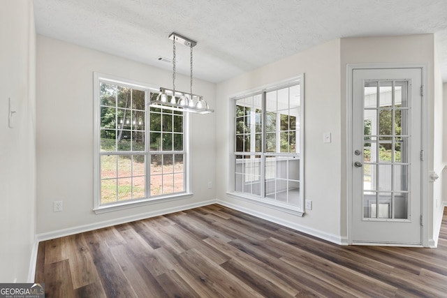 501 Llewellyn Ct, Jenkinsburg, GA 30234 - unfurnished dining area featuring dark wood-type flooring, a textured ceiling, and a chandelier
