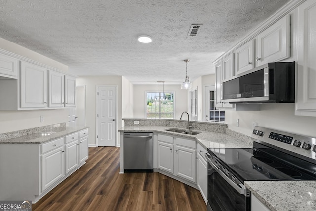 501 Llewellyn Ct, Jenkinsburg, GA 30234 - kitchen with appliances with stainless steel finishes, a peninsula, white cabinets, dark wood finished floors, and a textured ceiling