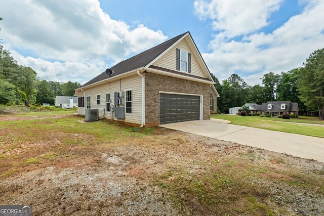501 Llewellyn Ct, Jenkinsburg, GA 30234 - view of side of home with brick siding, concrete driveway, a yard, and a garage