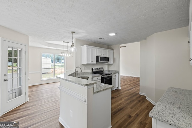 501 Llewellyn Ct, Jenkinsburg, GA 30234 - kitchen featuring appliances with stainless steel finishes, a peninsula, a textured ceiling, dark wood-type flooring, and white cabinetry