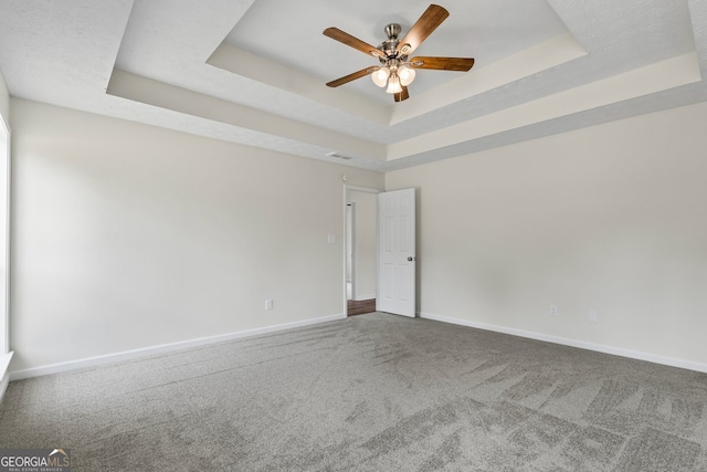 501 Llewellyn Ct, Jenkinsburg, GA 30234 - spare room featuring a tray ceiling, carpet, and ceiling fan