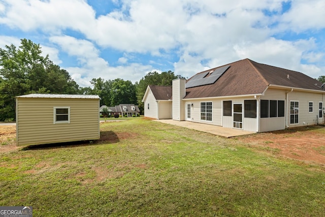 501 Llewellyn Ct, Jenkinsburg, GA 30234 - view of green lawn featuring a patio area, a sunroom, and an outbuilding