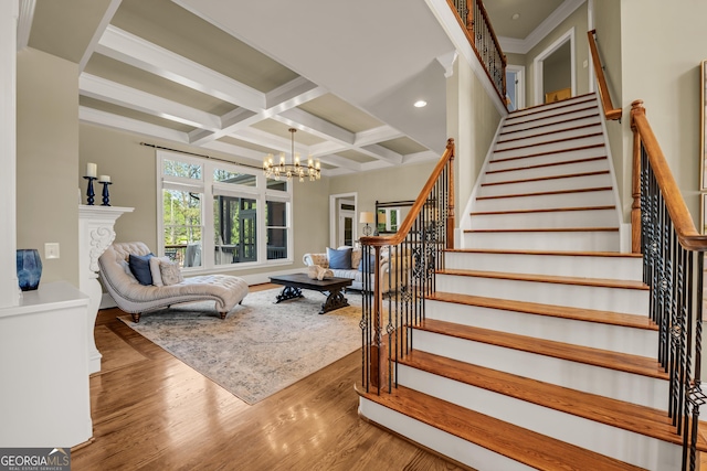 560 Arcaro Dr, Milton, GA 30004 - stairway with a chandelier, coffered ceiling, wood finished floors, beam ceiling, and crown molding